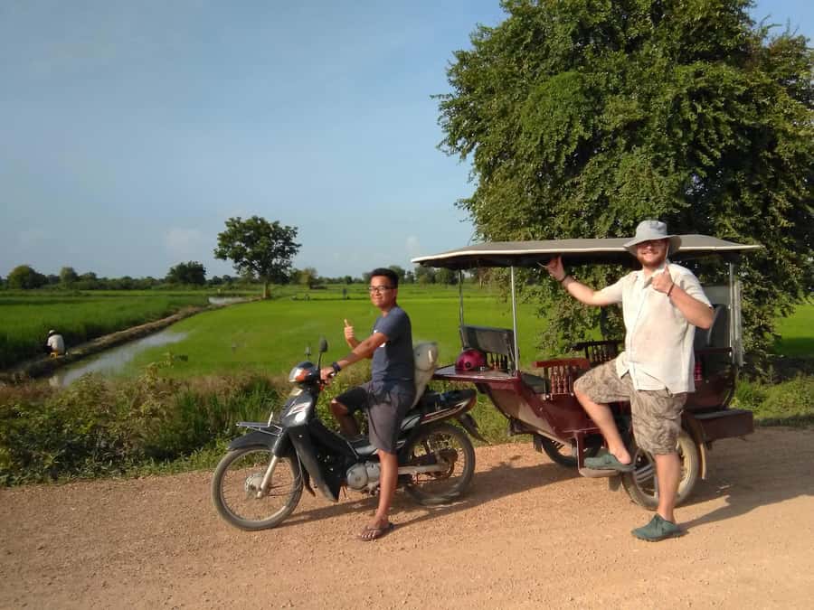 Battambang family tuktuk tour BambooTrain/Wat Banan/Bat cave - Riding the bamboo train through the fields