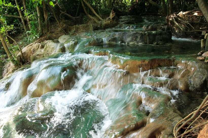 Krabi: Emerald Pool, Hot Waterfall, & Tiger Cave Temple Tour - Sitting in Krabi’s geothermal springs
